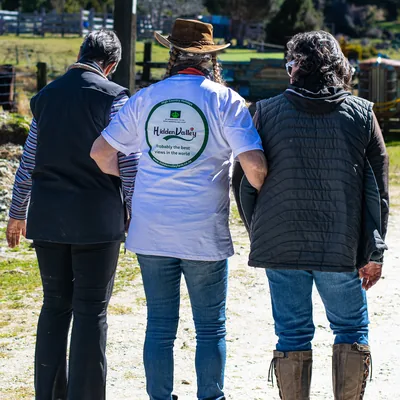 Three supporters walking arm in arm, one in a Hidden Valley shirt